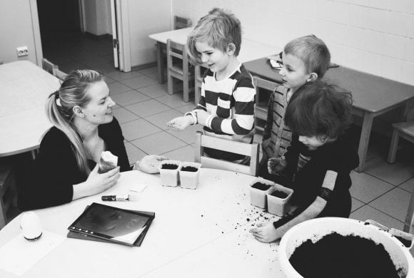 a woman teaching kids to do some tasks