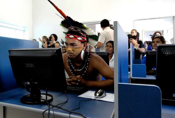 it support companies also support Young brazilian man checks out the new computer center in the braziil city such changes