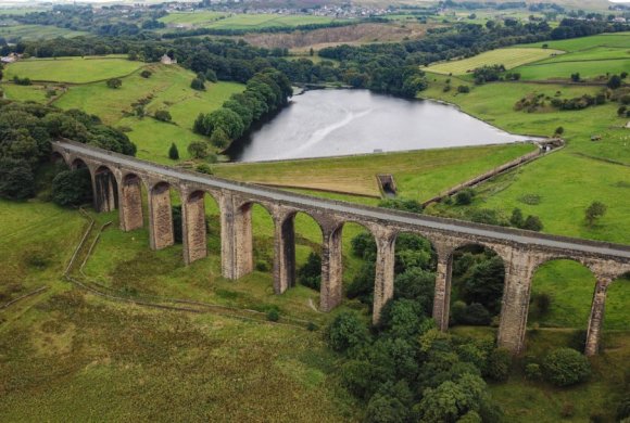 concrete conjunction surrounded by trees and lake